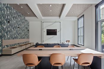 a conference room with a wooden table and chairs and a couch